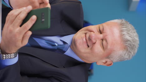 Vertical-video-of-Businessman-texting-on-the-phone.